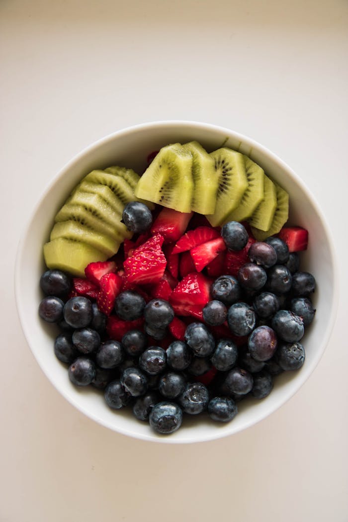 A delicious and colorful fruit bowl featuring blueberries, kiwi, and strawberries.